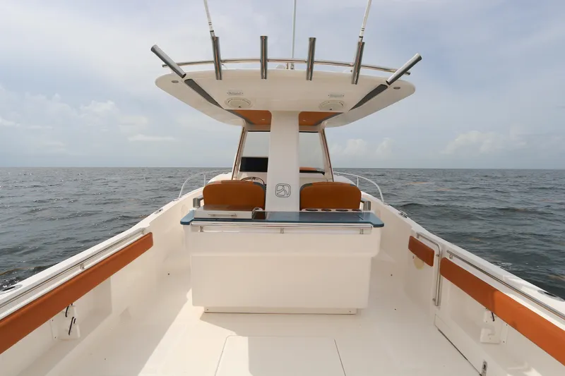 Slide: The Image of 2018 Belzona 327 Walkaround boat on open water, featuring spacious deck and seating. - 9