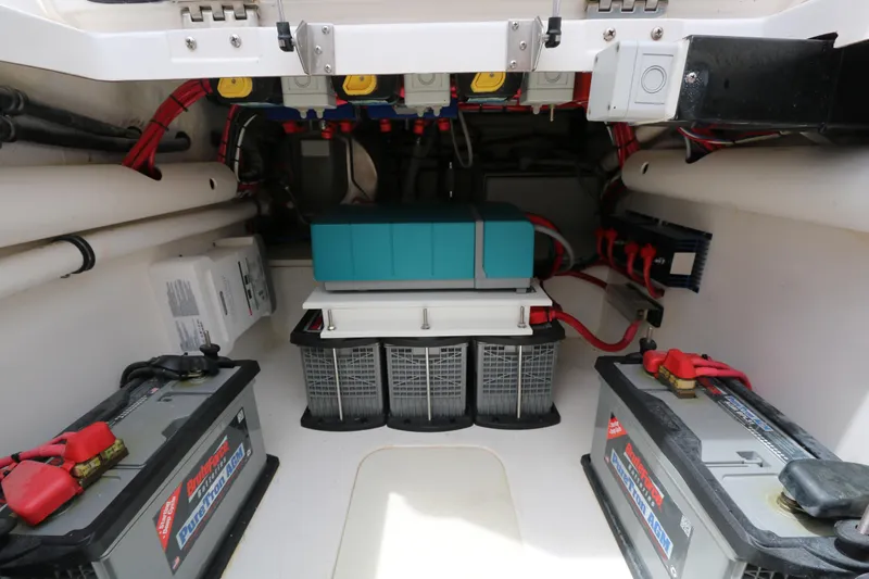 Slide: The Image of Electrical system inside a 2018 Belzona 327 Walkaround boat, featuring batteries and wiring. - 12