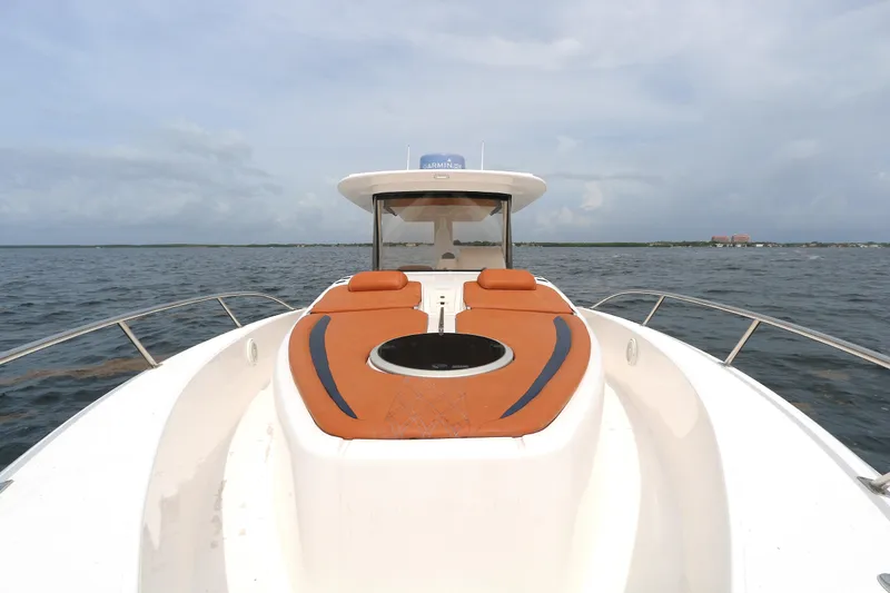 Slide: The Image of 2018 Belzona 327 Walkaround boat with orange seating on open water. - 4