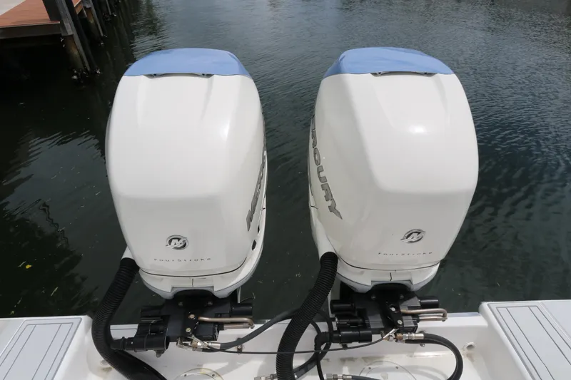 Slide: The Image of Twin Mercury outboard engines on a 2018 Belzona 327 Walkaround boat. - 15