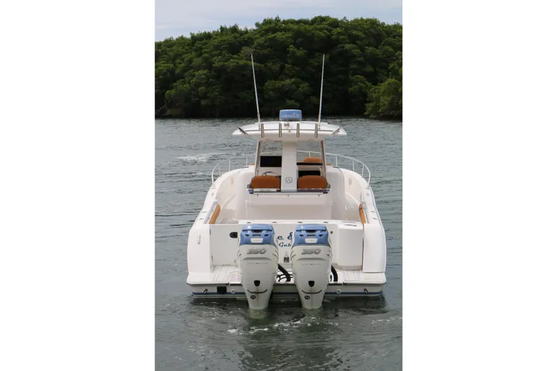 Slide: The Image of 2018 Belzona 327 Walkaround boat with dual outboard engines on a calm waterway. - 16