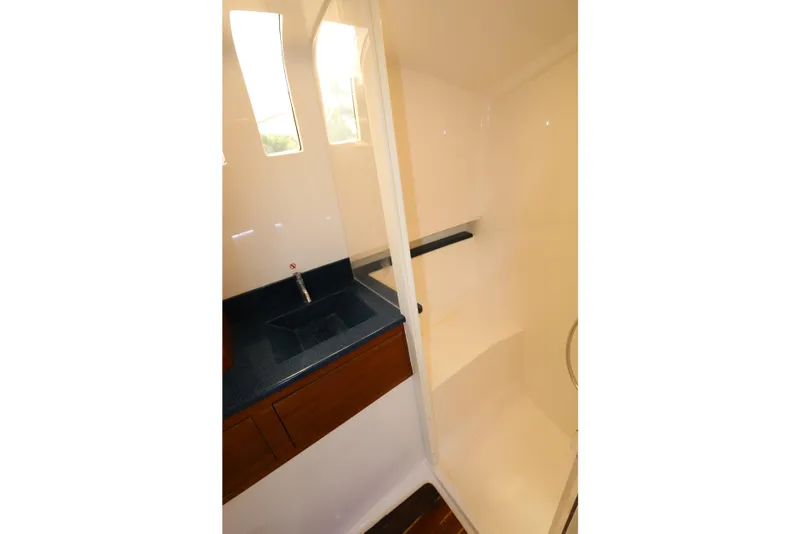 Slide: The Image of 2018 Belzona 327 Walkaround boat interior with sink and window. - 6