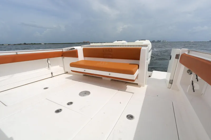 Slide: The Image of 2018 Belzona 327 Walkaround boat with orange seating, cruising on open water. - 10