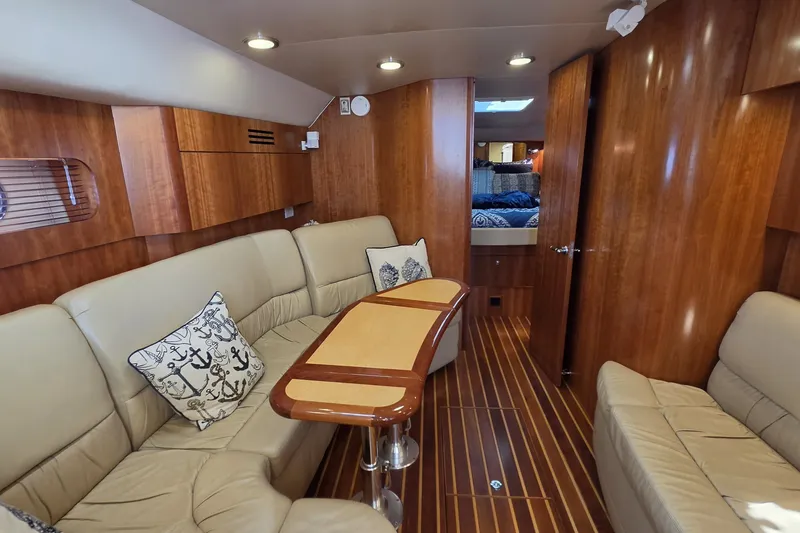 Slide: The Image of Luxurious interior of 2004 Tiara Yachts 4400 Sovran with elegant wood finish and plush seating. - 24