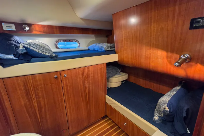 Slide: The Image of Interior cabin of 2004 Tiara Yachts 4400 Sovran with wooden finish and cozy bedding. - 37