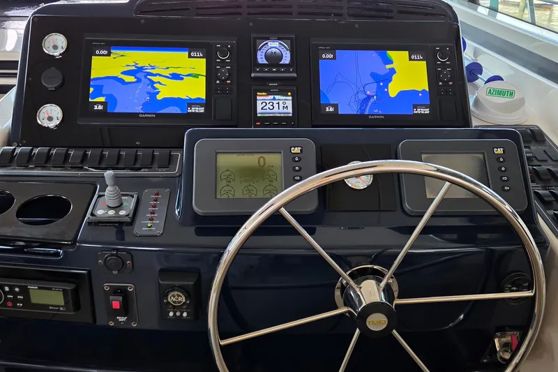 Slide: The Image of Dashboard of a 2004 Tiara Yachts 4400 Sovran with navigation screens and controls. - 21