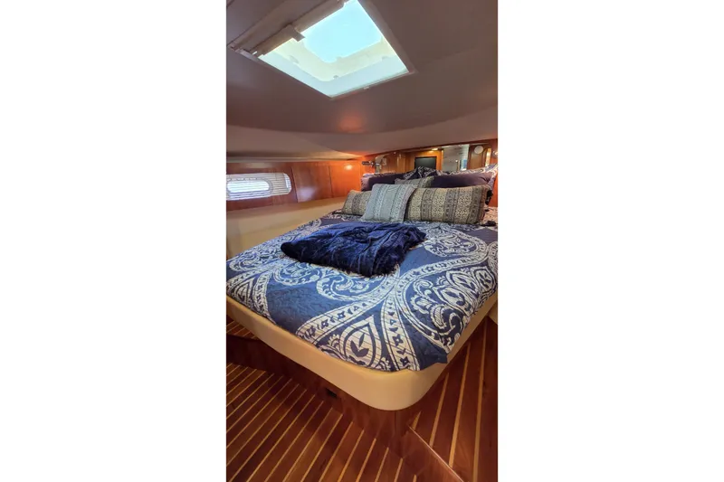 Slide: The Image of Luxurious cabin interior of 2004 Tiara Yachts 4400 Sovran with elegant bedding and skylight. - 34