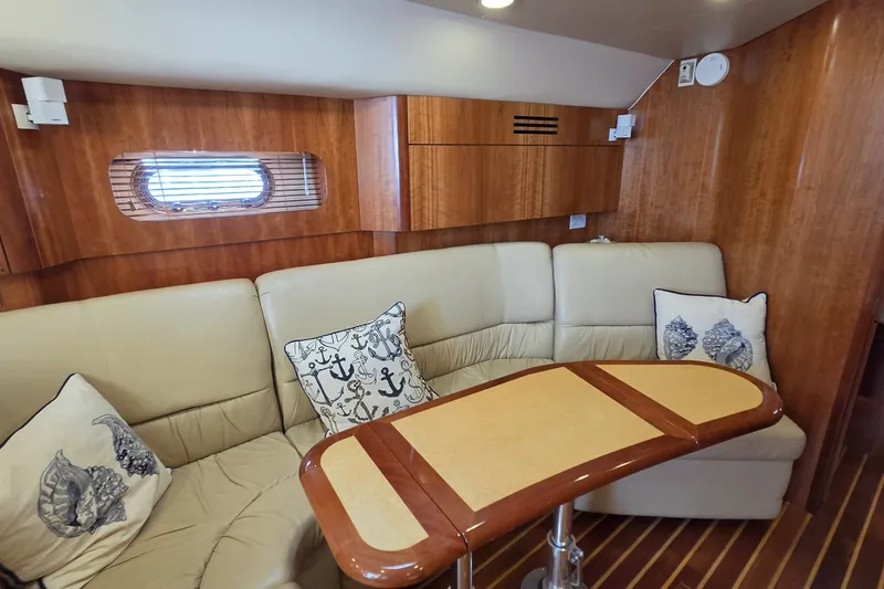 Slide: The Image of Luxurious interior of 2004 Tiara Yachts 4400 Sovran with elegant seating and nautical-themed pillows. - 27