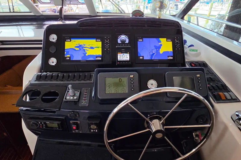 Slide: The Image of Helm of 2004 Tiara Yachts 4400 Sovran with navigation screens and controls. - 22