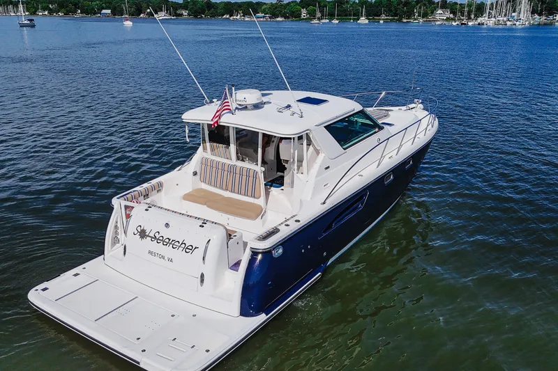 Slide: The Image of 2004 Tiara Yachts 4400 Sovran cruising on a serene lake. - 4