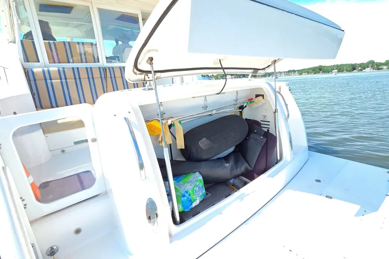 Slide: The Image of Open storage compartment on a 2004 Tiara Yachts 4400 Sovran, docked by the water. - 15
