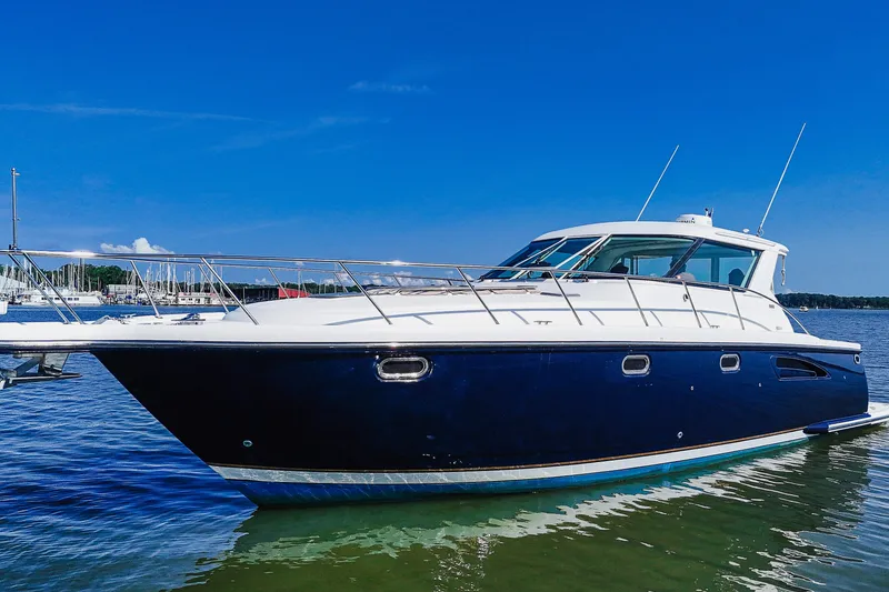 Slide: The Image of 2004 Tiara Yachts 4400 Sovran in calm waters under a clear blue sky. - 2
