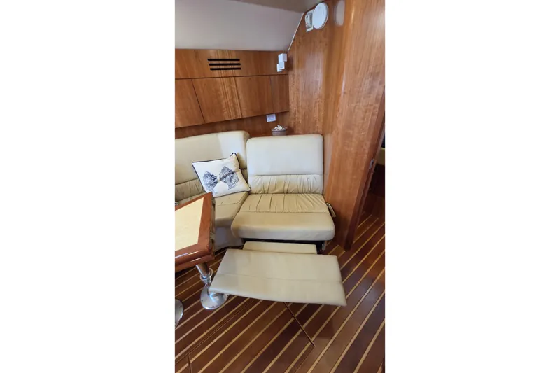 Slide: The Image of Interior of 2004 Tiara Yachts 4400 Sovran with beige seating and wooden accents. - 28