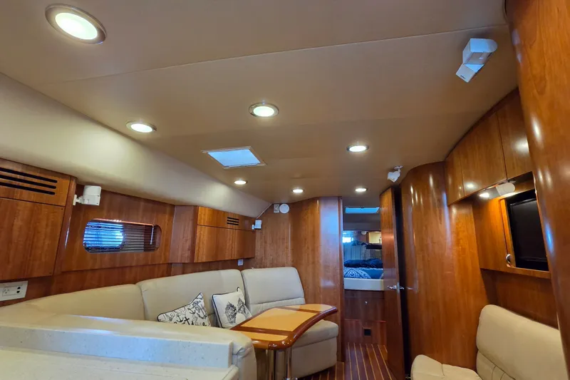 Slide: The Image of Luxurious interior of 2004 Tiara Yachts 4400 Sovran with wood paneling and cozy seating. - 25