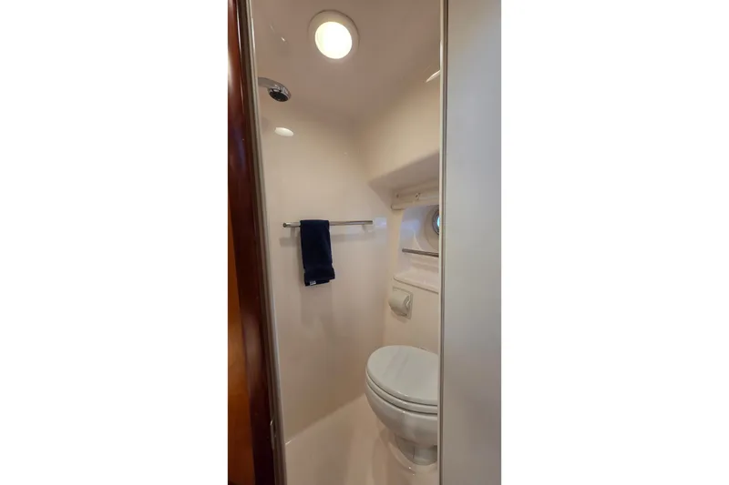 Slide: The Image of Bathroom interior of 2004 Tiara Yachts 4400 Sovran, featuring toilet and towel rack. - 39