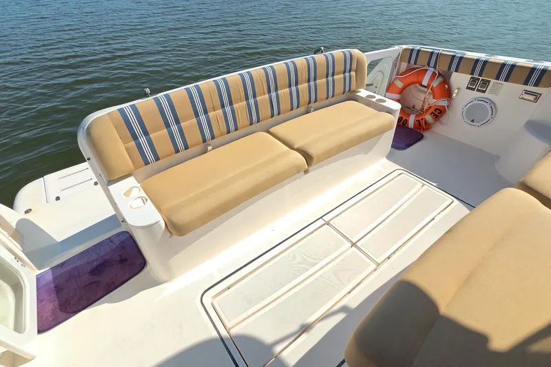 Slide: The Image of 2004 Tiara Yachts 4400 Sovran boat deck with striped seating and life preserver. - 16