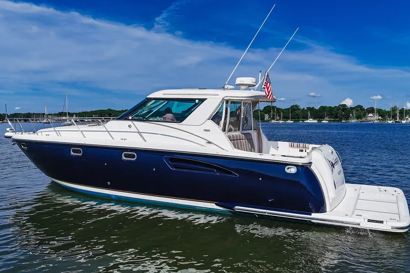 Slide: The Image of 2004 Tiara Yachts 4400 Sovran in calm waters, showcasing sleek design and luxury features. - 3