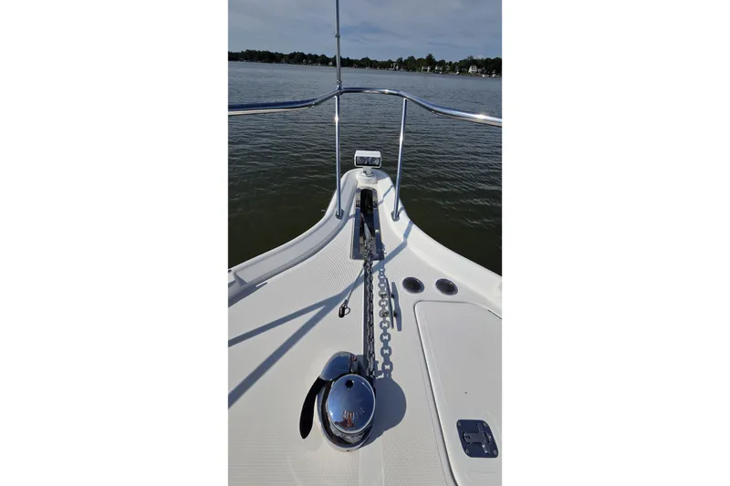 Slide: The Image of Bow view of 2004 Tiara Yachts 4400 Sovran, featuring anchor chain and calm waters. - 7
