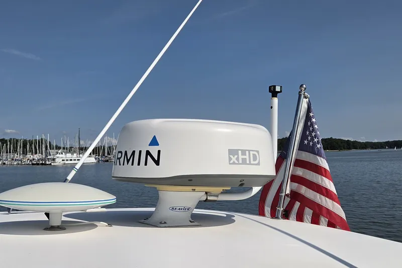 Slide: The Image of Radar and American flag on 2004 Tiara Yachts 4400 Sovran, docked by a marina. - 13