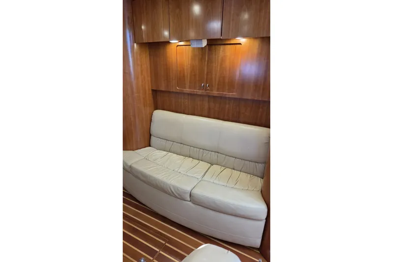 Slide: The Image of Luxurious interior of 2004 Tiara Yachts 4400 Sovran with leather seating and wooden cabinetry. - 29