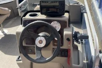Slide: The Image of 2023 Sun Tracker Bass Buggy 18 DLX steering console with navigation system and controls. - 3