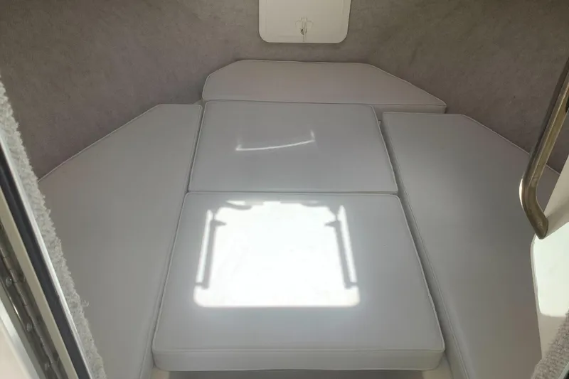 Slide: The Image of Interior cabin of 2012 Parker 2520 XL Sport Cabin boat with white cushions. - 15