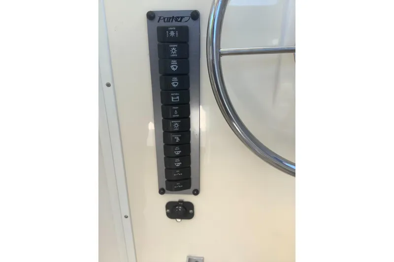 Slide: The Image of Control panel of a 2012 Parker 2520 XL Sport Cabin boat with labeled switches. - 11