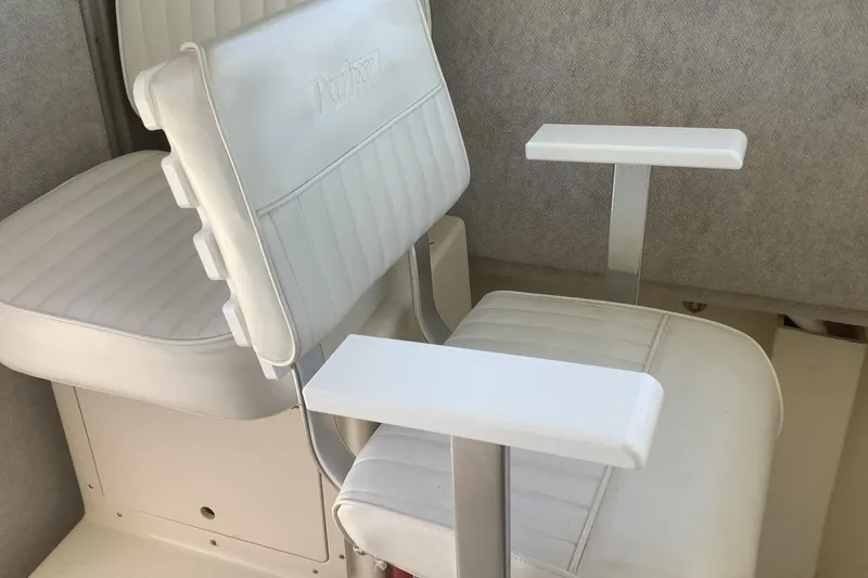 Slide: The Image of White seating in a 2012 Parker 2520 XL Sport Cabin boat interior. - 13
