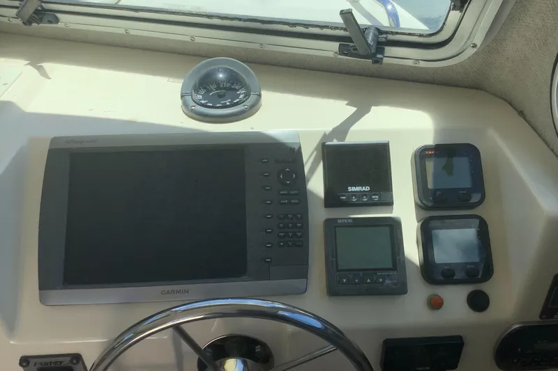 Slide: The Image of Dashboard of a 2012 Parker 2520 XL Sport Cabin with navigation instruments and steering wheel. - 9