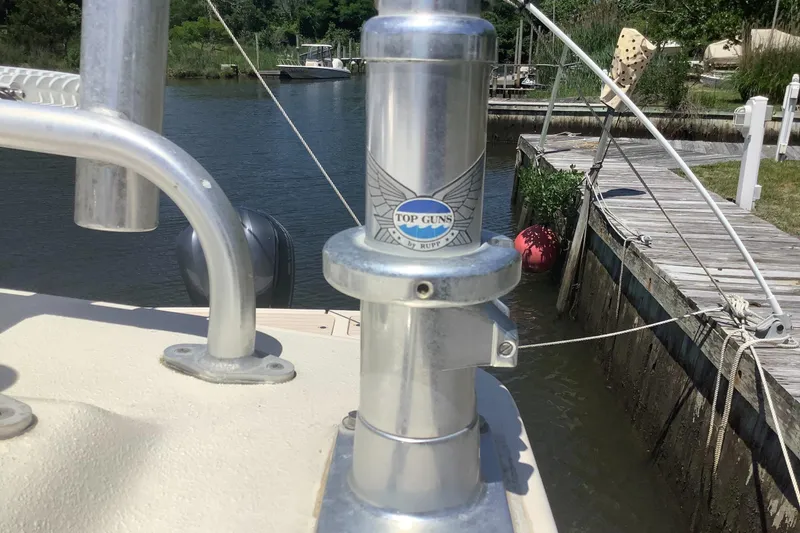 Slide: The Image of Close-up of a 2012 Parker 2520 XL Sport Cabin boat with "Top Guns" label. - 5