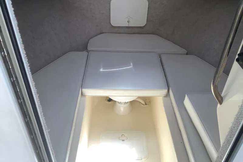 Slide: The Image of Interior cabin of 2012 Parker 2520 XL Sport Cabin boat, featuring cushioned seating. - 16