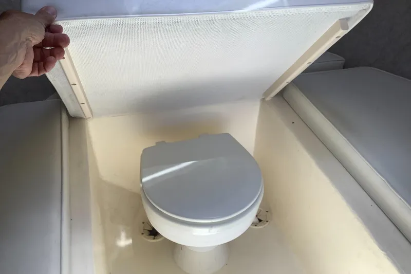 Slide: The Image of Boat toilet in 2012 Parker 2520 XL Sport Cabin, under a hinged cover. - 17