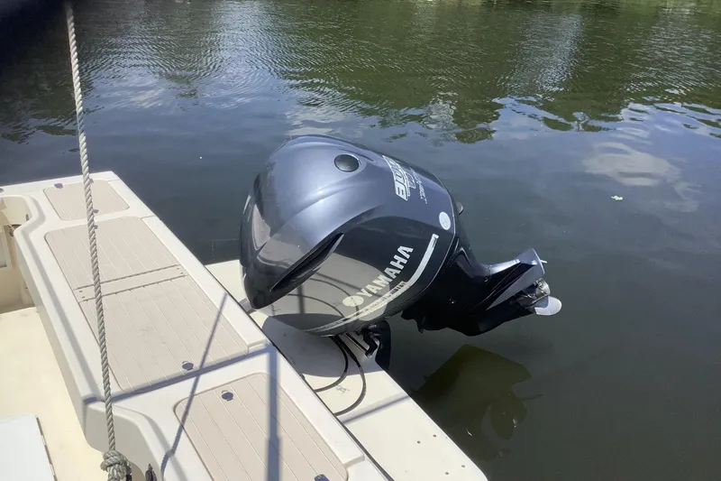 Slide: The Image of 2012 Parker 2520 XL Sport Cabin with Yamaha outboard motor on calm water. - 3