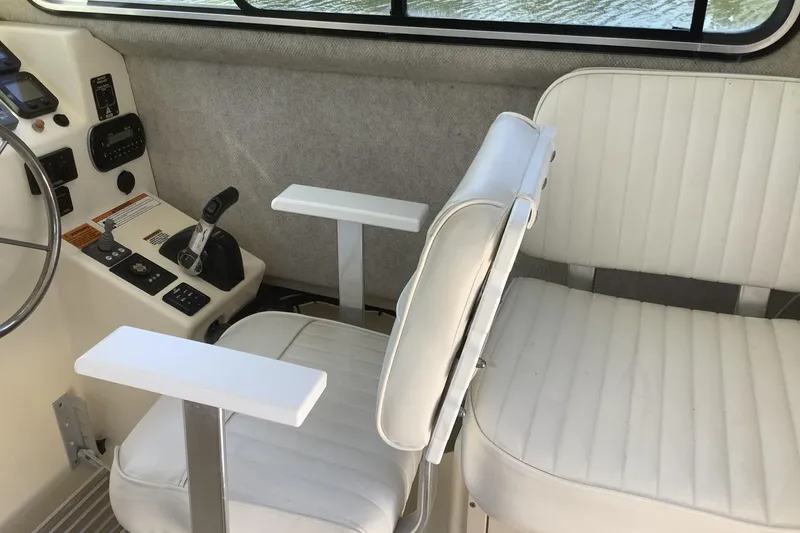 Slide: The Image of Interior of 2012 Parker 2520 XL Sport Cabin with white seating and control panel. - 12