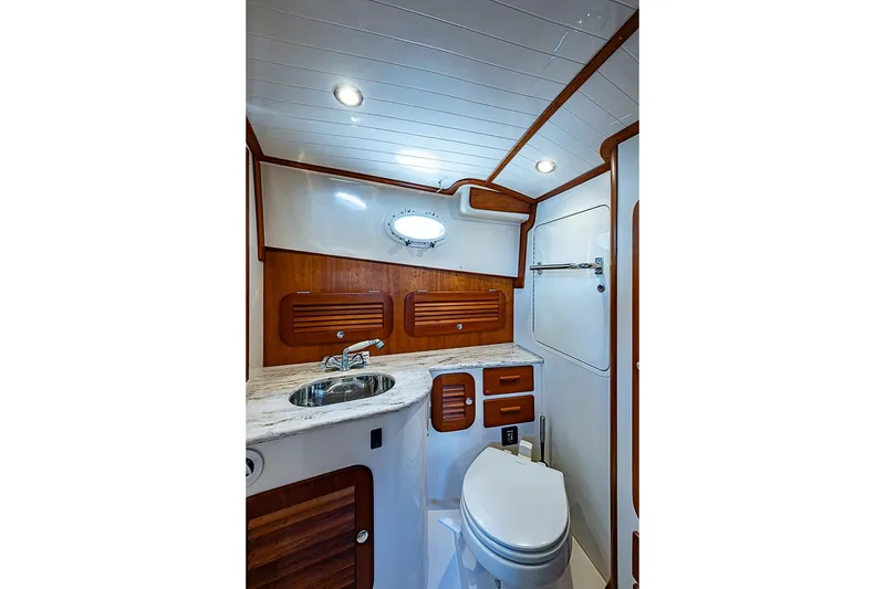 Slide: The Image of Luxurious 2013 Hinckley Talaria 34 yacht bathroom with wood accents and modern fixtures. - 15