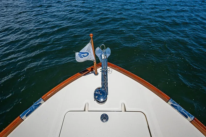 Slide: The Image of Bow of 2013 Hinckley Talaria 34 yacht with flag, on calm water. - 17