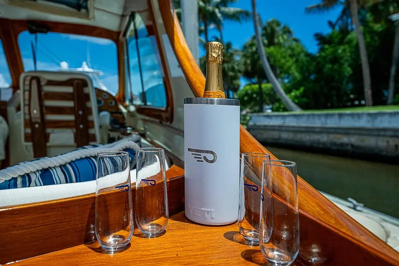 Slide: The Image of 2013 Hinckley Talaria 34 interior with champagne and glasses, showcasing luxury boating experience. - 7