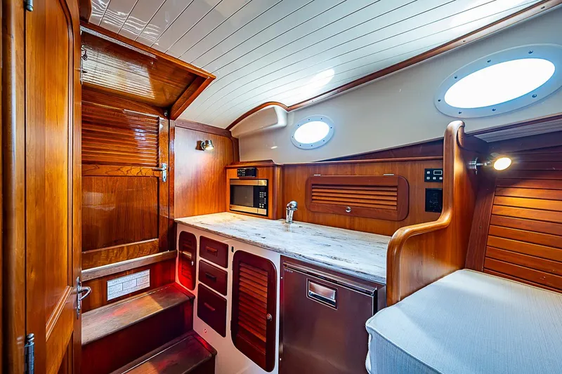 Slide: The Image of Interior of 2013 Hinckley Talaria 34 yacht with wooden cabinetry and modern amenities. - 13
