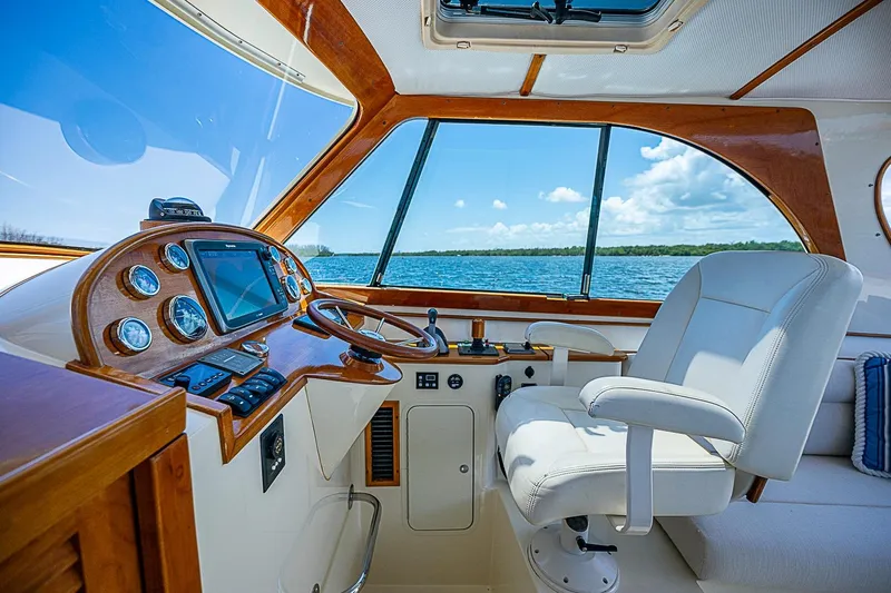 Slide: The Image of Interior of 2013 Hinckley Talaria 34 yacht, featuring elegant helm and luxurious seating. - 10
