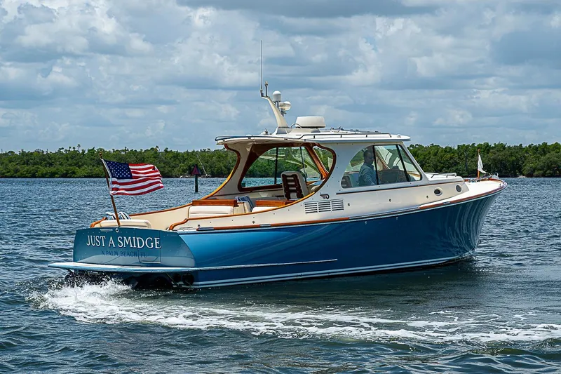 Slide: The Image of 2013 Hinckley Talaria 34 yacht cruising on water with American flag. - 3