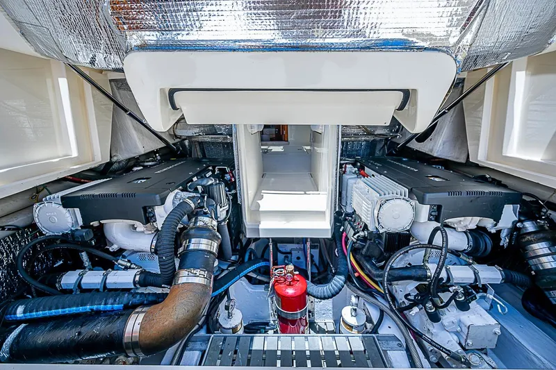 Slide: The Image of Engine room of 2013 Hinckley Talaria 34, showcasing dual engines and mechanical components. - 19