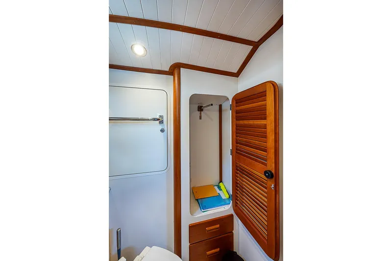 Slide: The Image of Interior of 2013 Hinckley Talaria 34, featuring wooden cabinetry and modern design elements. - 16