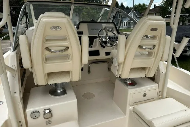 Slide: The Image of 2025 Grady-White Gulfstream 232 boat interior with dual helm seats and steering console. - 21