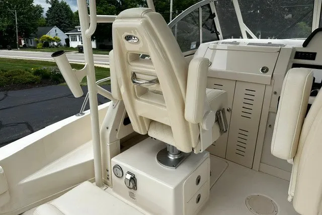 Slide: The Image of 2025 Grady-White Gulfstream 232 boat interior with helm seating and control panel. - 35