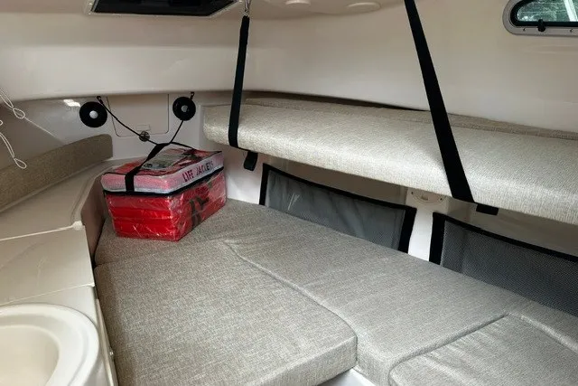 Slide: The Image of 2025 Grady-White Gulfstream 232 cabin interior with seating and life jacket storage. - 45