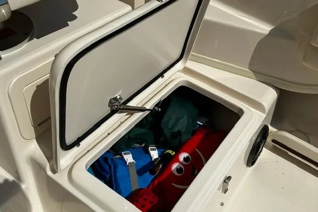 Slide: The Image of Open storage compartment on 2025 Grady-White Gulfstream 232 boat with gear inside. - 25