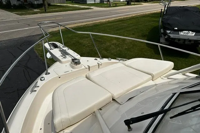 Slide: The Image of 2025 Grady-White Gulfstream 232 boat with cushioned bow seating and stainless steel railings. - 48