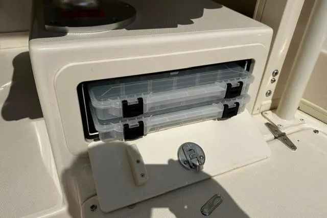 Slide: The Image of Storage compartment with tackle boxes on a 2025 Grady-White Gulfstream 232 boat. - 24
