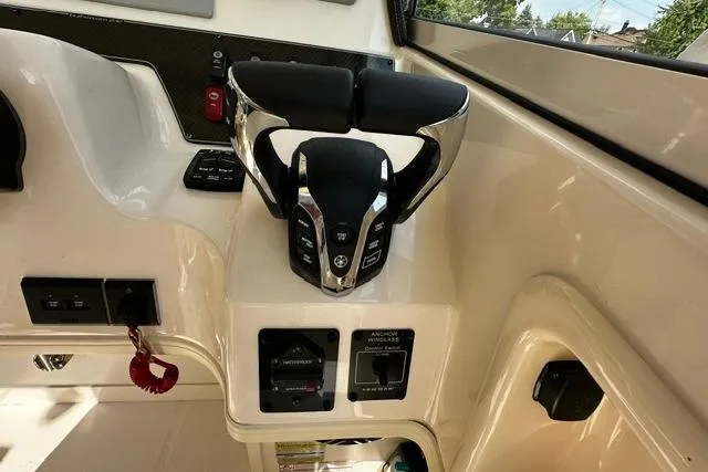 Slide: The Image of 2025 Grady-White Gulfstream 232 helm with modern controls and steering wheel. - 31