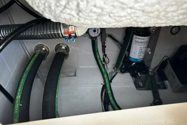 Slide: The Image of Interior view of 2025 Grady-White Gulfstream 232 boat showing hoses and Shurflo pump system. - 16